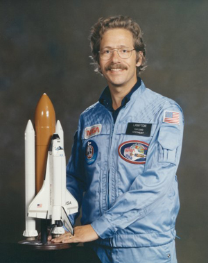Michael Logan Lampton holding a model space shuttle.